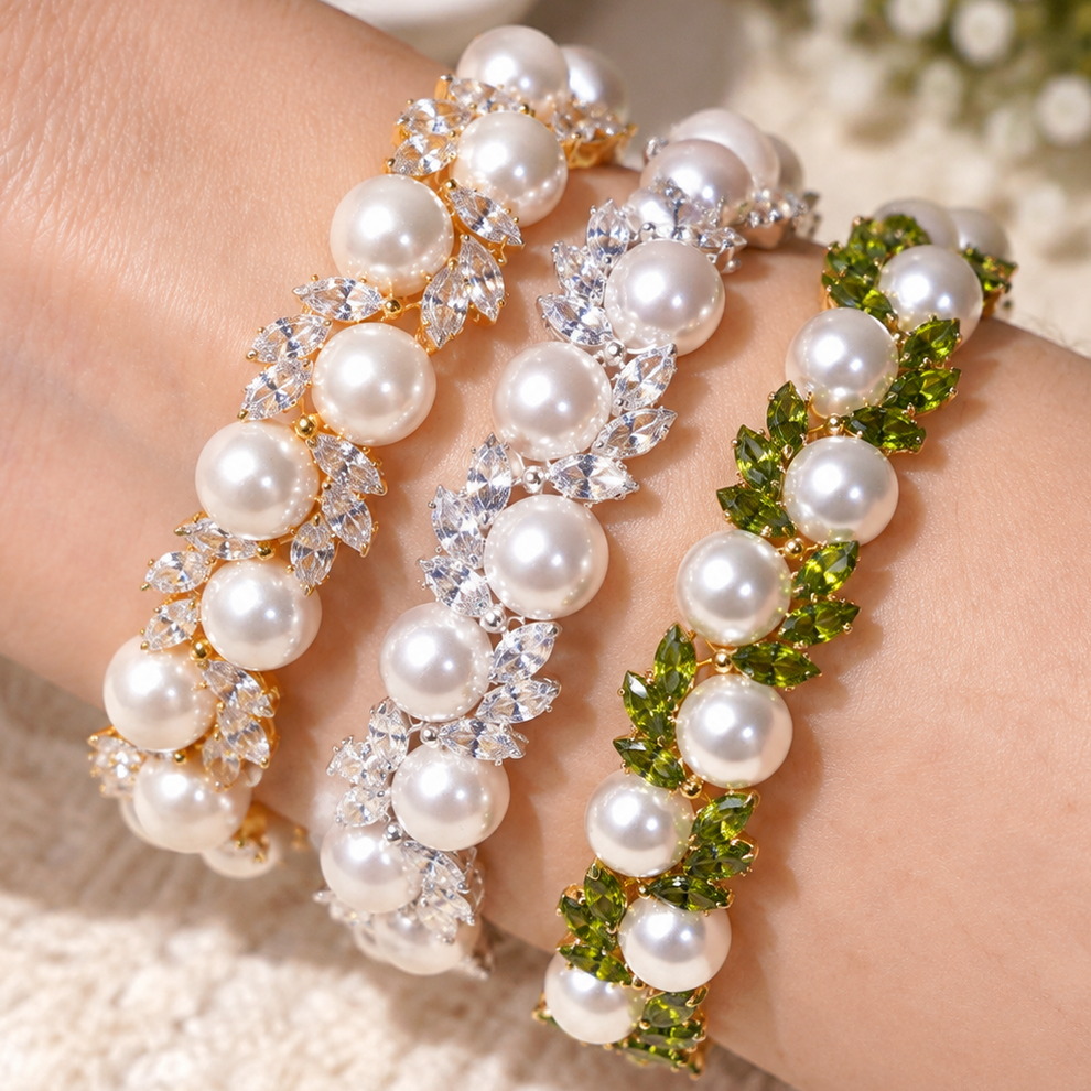 Three variations of Kit 131 pearl and marquise cubic zirconia bracelets stacked on one wrist
